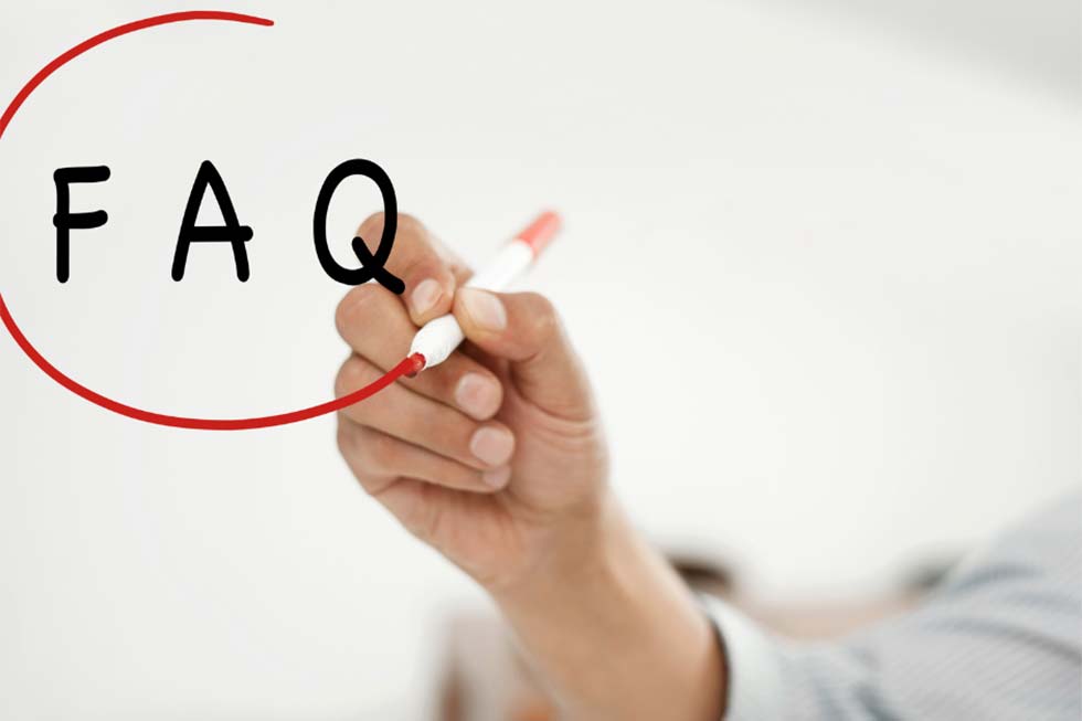 Woman drawing FAQ on a clear whiteboard